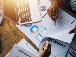 Group,Of,Confident,Business,People,Point,To,Graphs,And,Charts