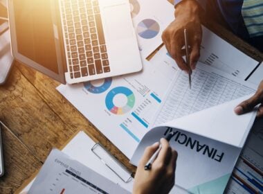 Group,Of,Confident,Business,People,Point,To,Graphs,And,Charts