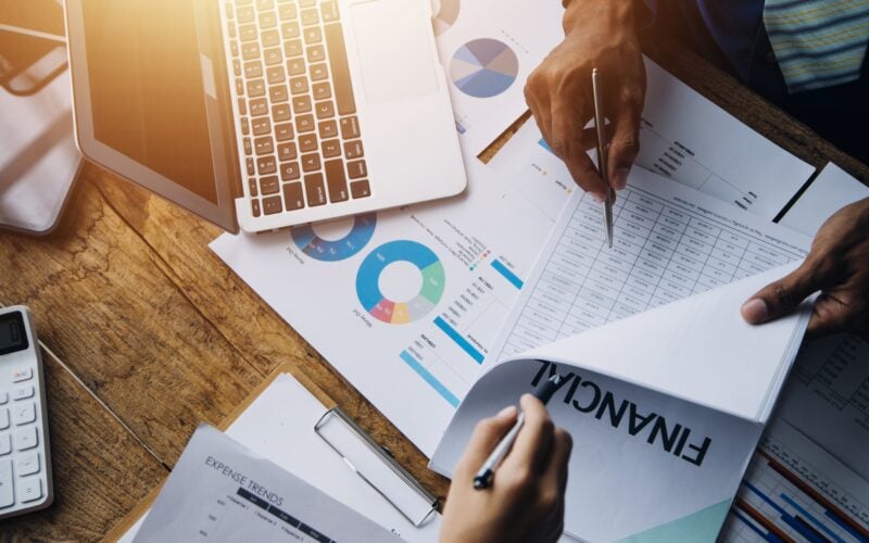 Group,Of,Confident,Business,People,Point,To,Graphs,And,Charts