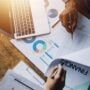 Group,Of,Confident,Business,People,Point,To,Graphs,And,Charts