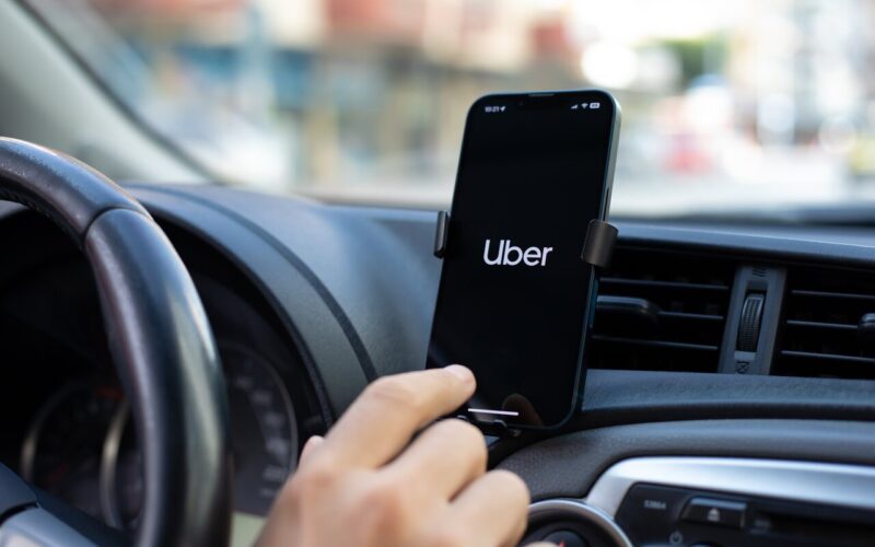 Apple iPhone 14 with application Taxi Uber in the screen. iPhone 14 was created and developed by the Apple inc.